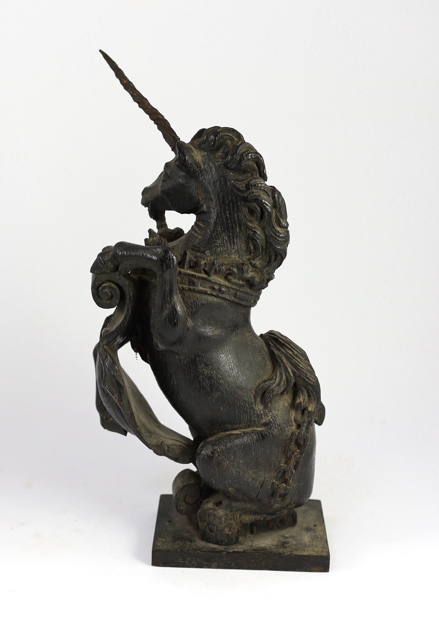 A pair of 18th century carved and ebonised oak heraldic beasts, lion and unicorn, 42cm high